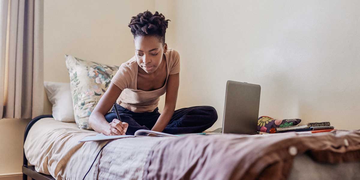 student studying on a bed