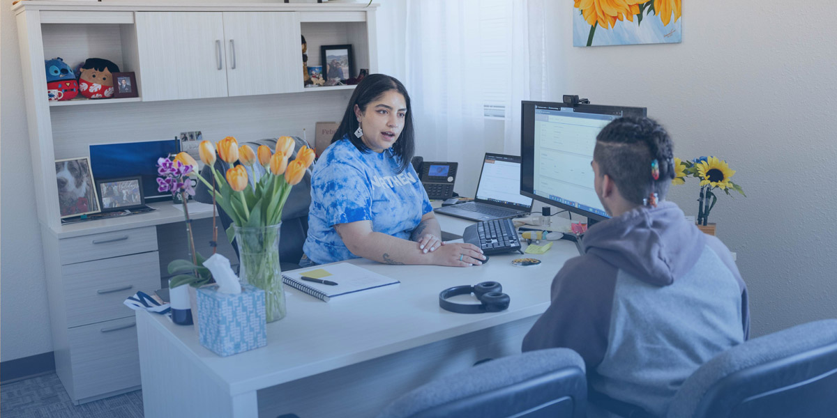 people meeting at a desk