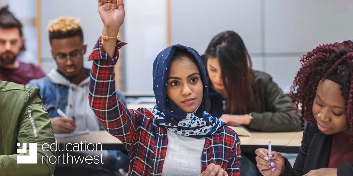 student raising hand in a classroom