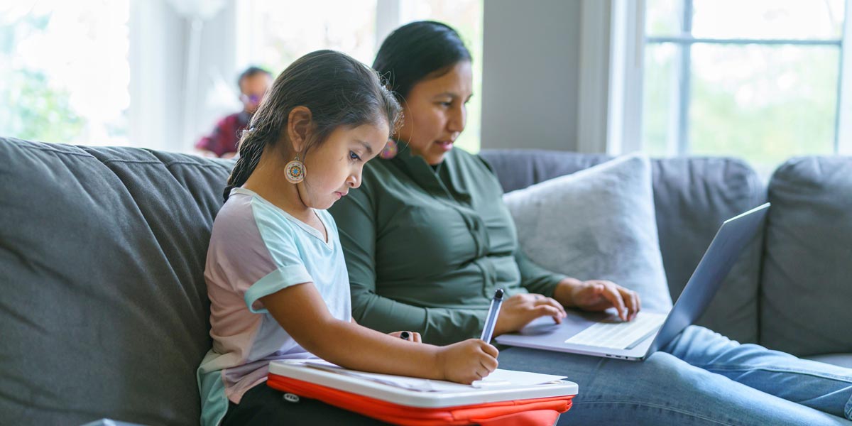 parent and child reading on a couch