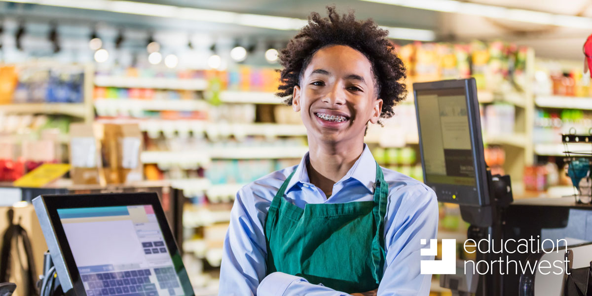 youth working at a grocery store register