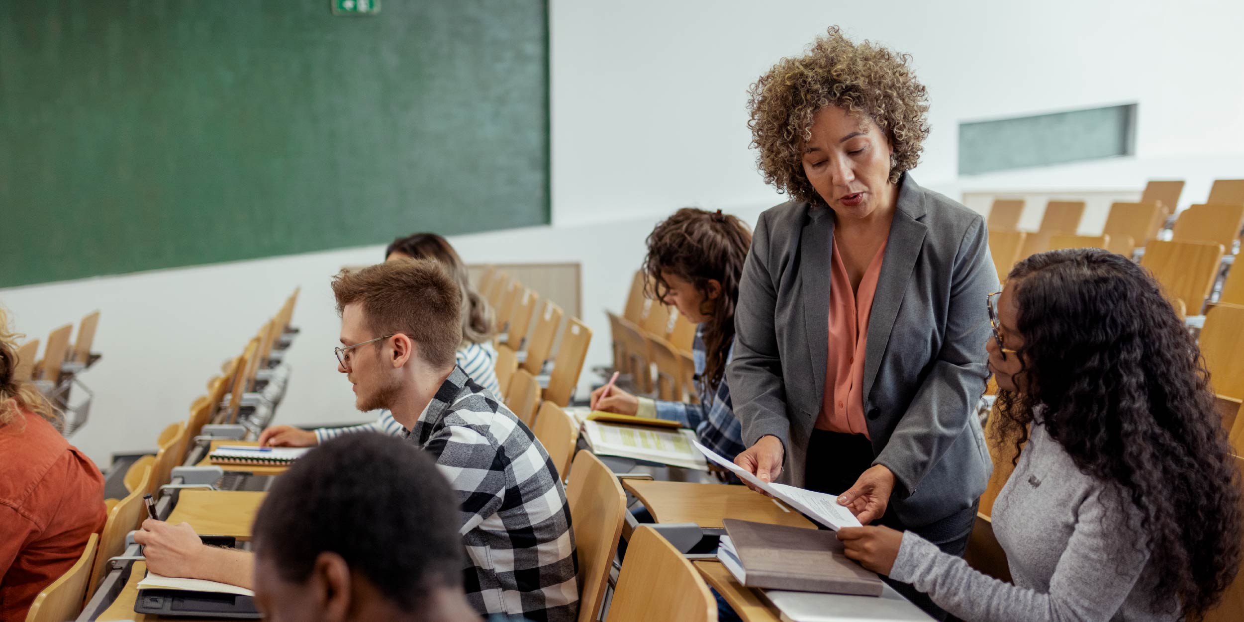 Teacher looking over a student's paper with a student