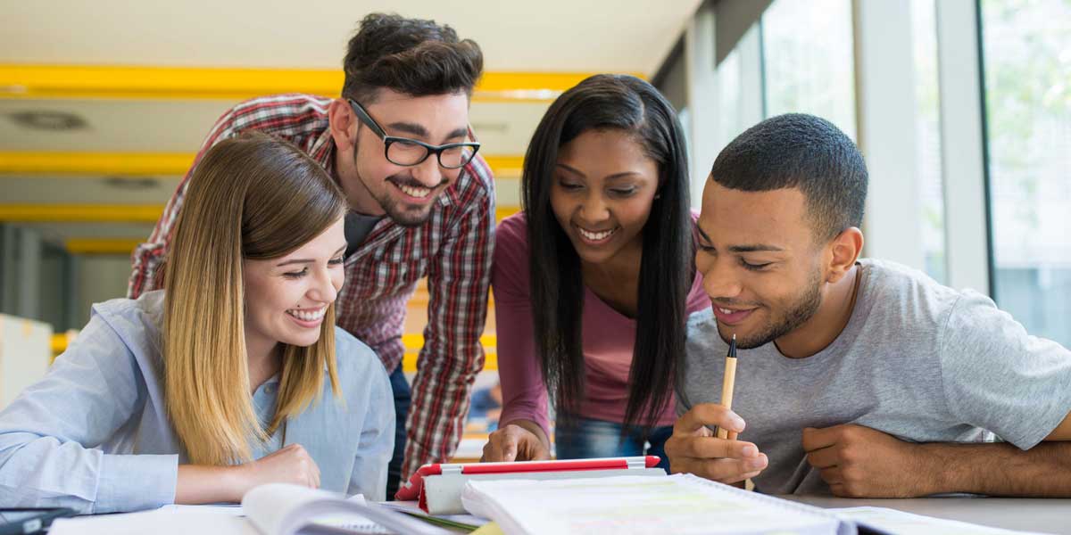 A group of students reading and writing together