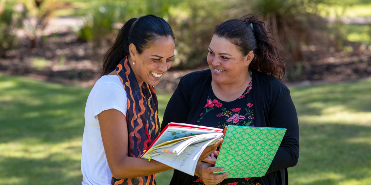 Two people going over notes and smiling