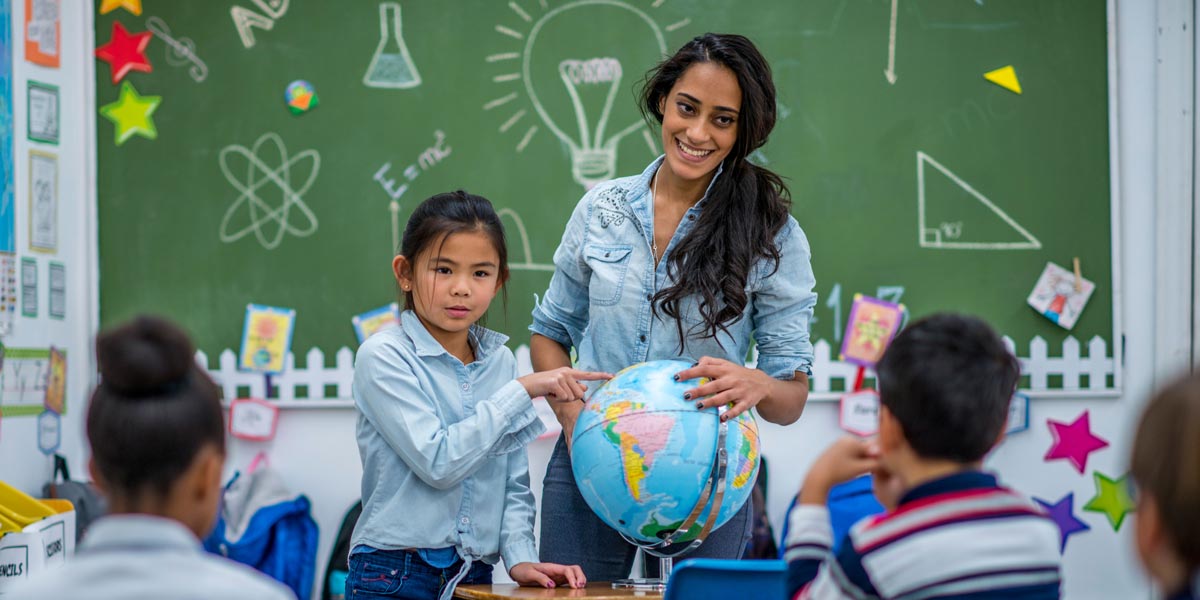 teacher with students in front of a classroom