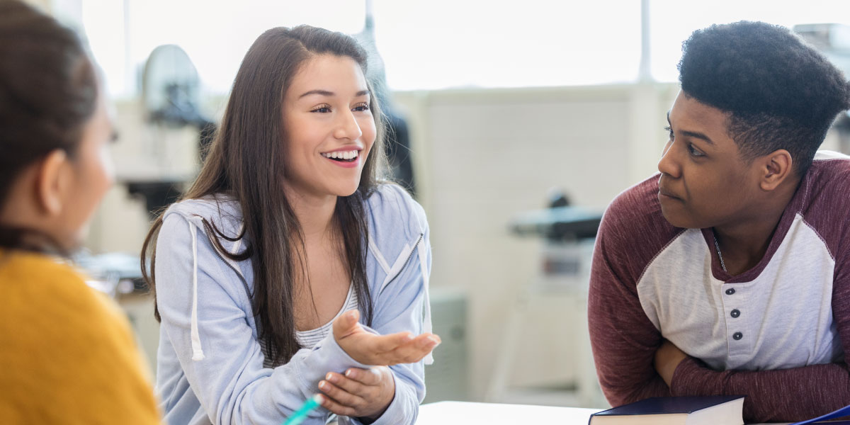 Three students having a conversation