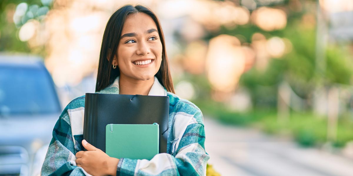 high school student holding a notebook