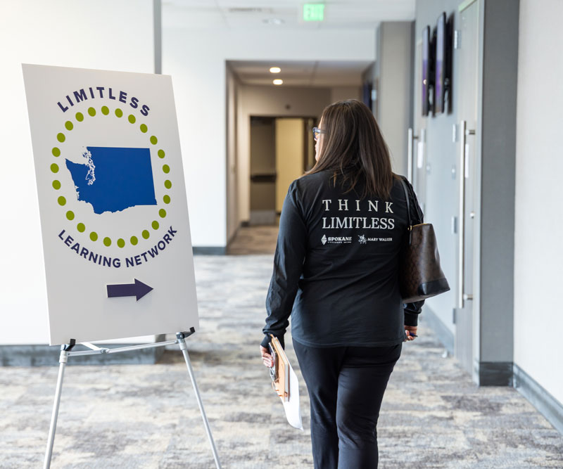 participant walks to a breakout session
