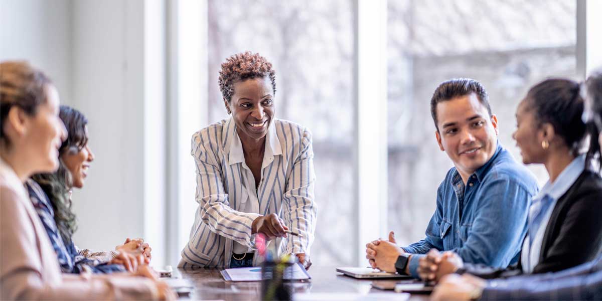 A group of people sitting around a table having a meeting