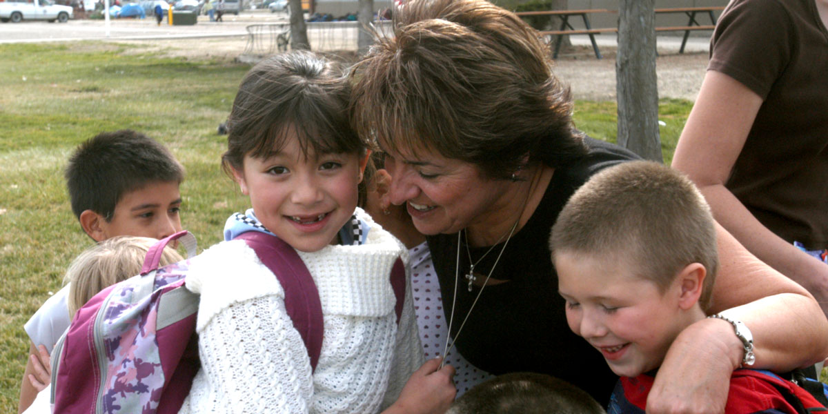 parent hugging two children