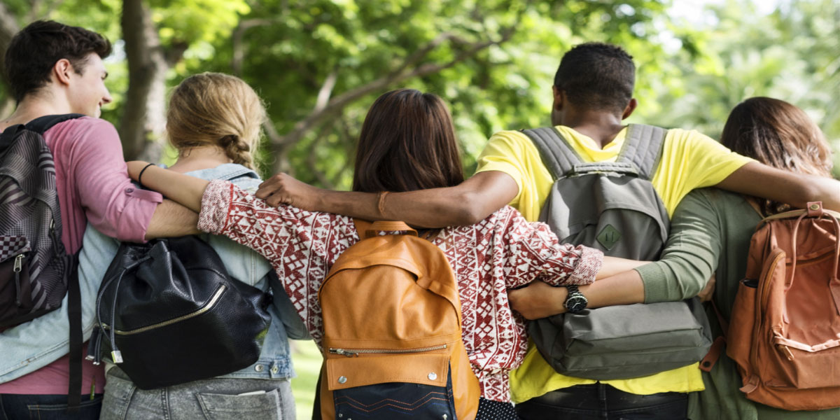 students walking with arms around eachother