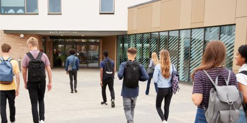 A group of students walking into a school building