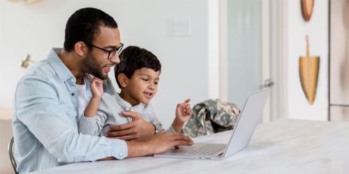 parent and student using a computer at home