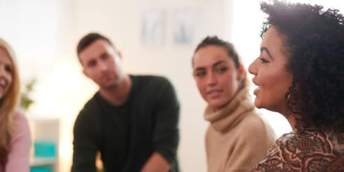 four adults talking