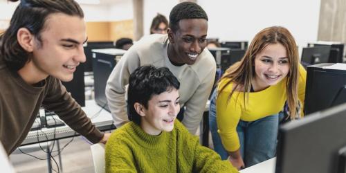 college students looking at a computer