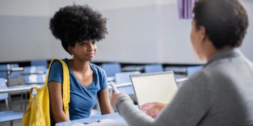 student being interviewed by a teacher